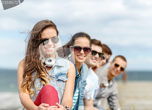 Image of smiling teenage girl hanging out with friends