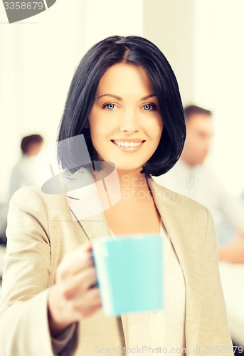 Image of beautiful businesswoman with cup of coffee