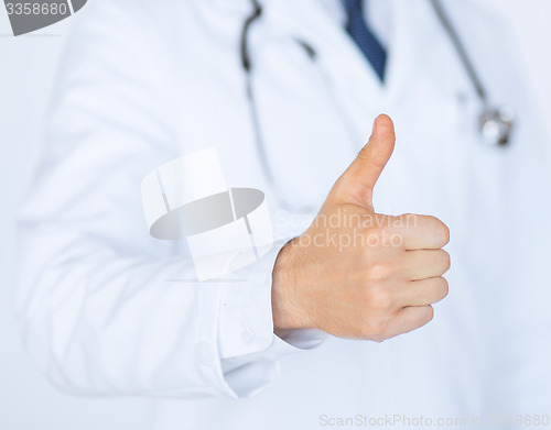 Image of male doctor hand showing thumbs up