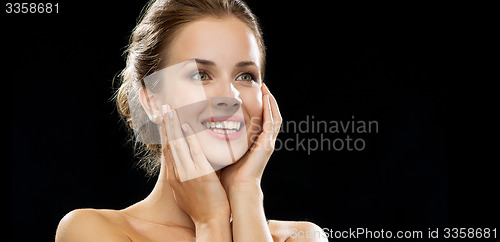 Image of happy excited woman face over black background