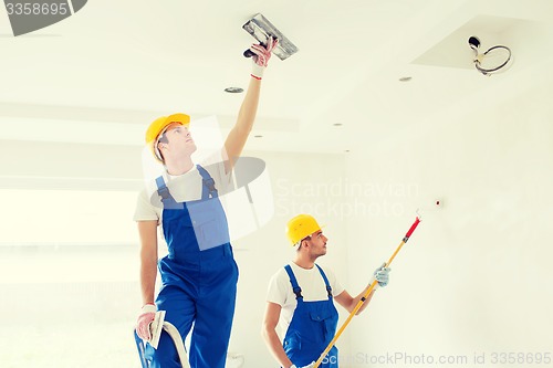 Image of group of builders with tools indoors