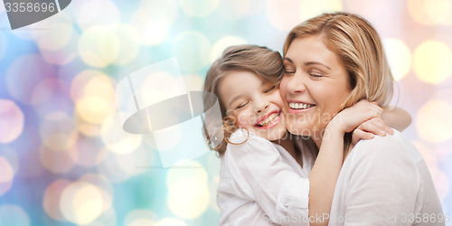 Image of happy mother and daughter hugging