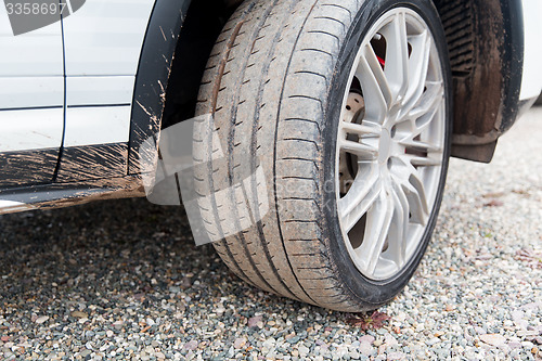 Image of close up of dirty car wheel on ground