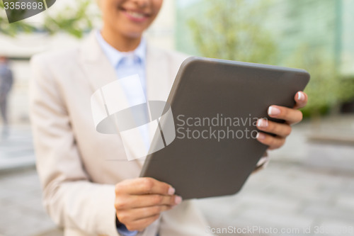 Image of close up of business woman with tablet pc in city