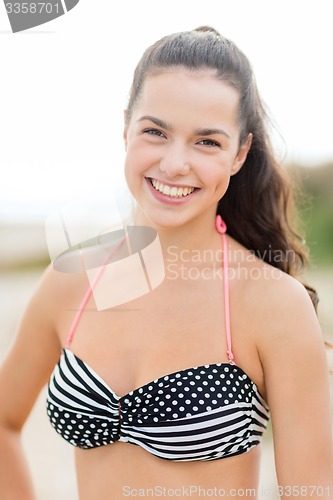 Image of happy young woman on beach