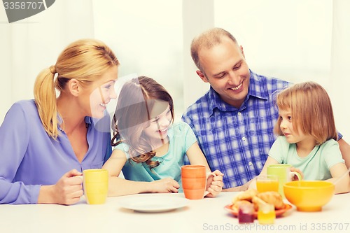 Image of happy family with two kids with having breakfast