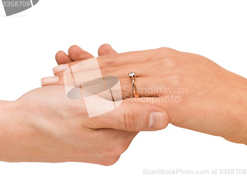 Image of man puts wedding ring on woman hand