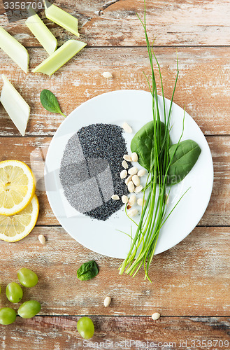 Image of close up of peanut, greens and poppy or chia seeds