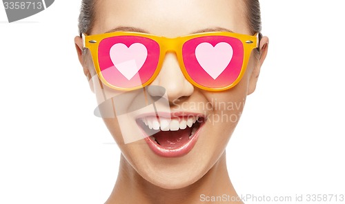 Image of happy teenage girl in shades with hearts