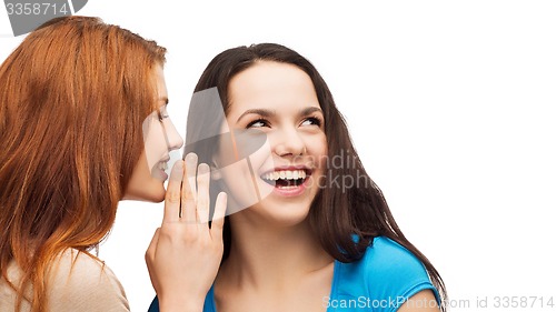 Image of one girl telling another secret