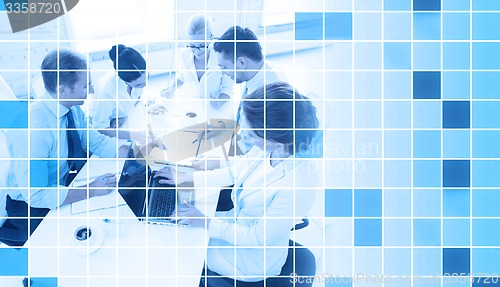 Image of business team with laptop and papers in office