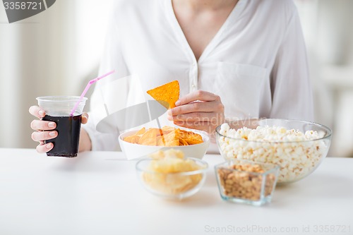 Image of close up of woman with junk food and coca cola cup