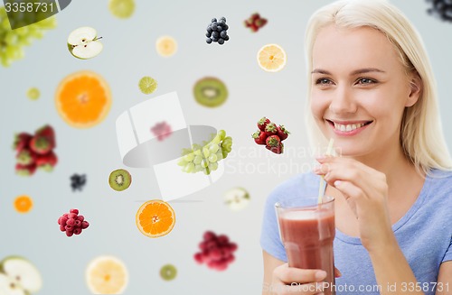Image of smiling woman drinking juice or shake at home