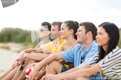 Image of group of happy friends on beach