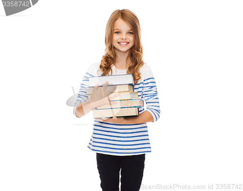 Image of little student girl with many books