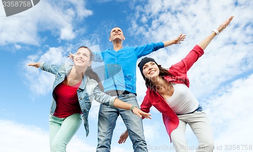 Image of group of teenagers spreading hands