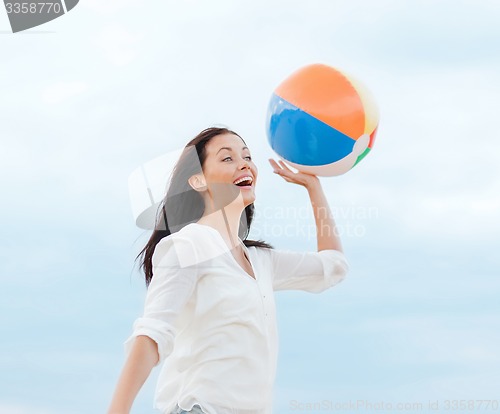 Image of girl with ball on the beach