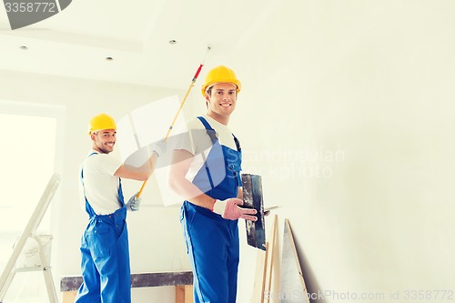 Image of group of builders with tools indoors