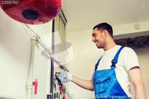 Image of builder or plumber working indoors