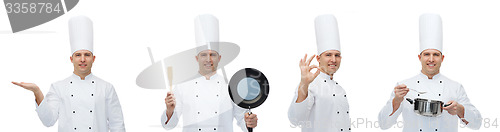Image of happy male chef with kitchen utensils showing ok
