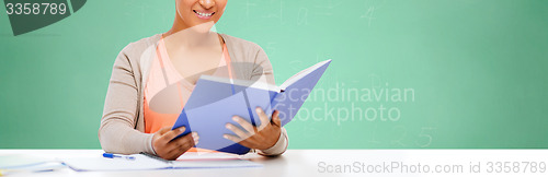 Image of afro american student girl reading book at school