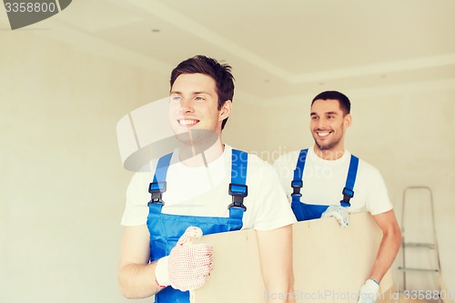 Image of group of builders with wooden boards