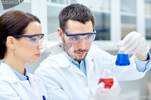 Image of young scientists making test or research in lab
