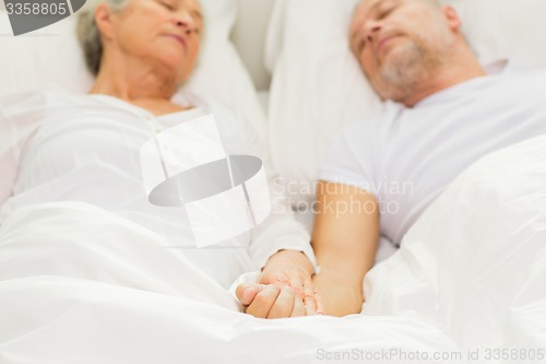 Image of close up of senior couple sleeping in bad at home