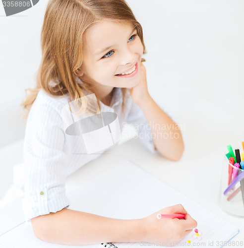 Image of little student girl drawing at school