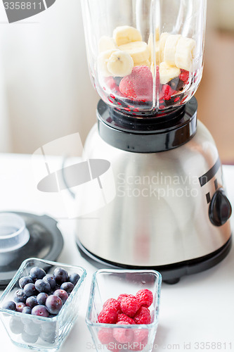 Image of close up of blender with berries and fruits