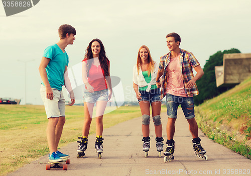 Image of group of smiling teenagers with roller-skates