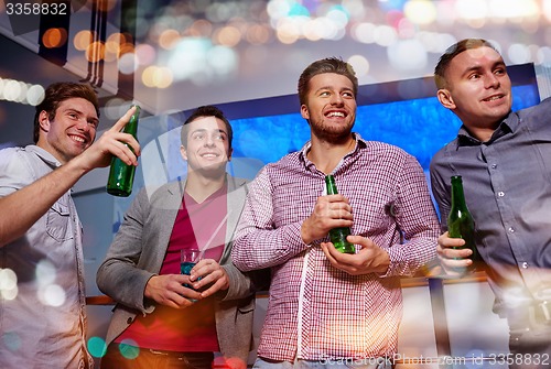 Image of group of male friends with beer in nightclub