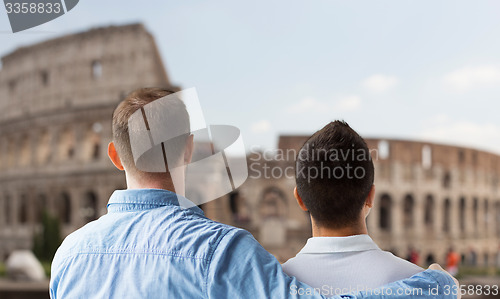 Image of close up of male gay couple over coliseum in rome