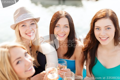 Image of smiling girls with champagne glasses