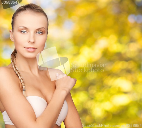 Image of beautiful young woman with bare shoulders