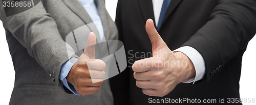 Image of businessman and businesswoman showing thumbs up