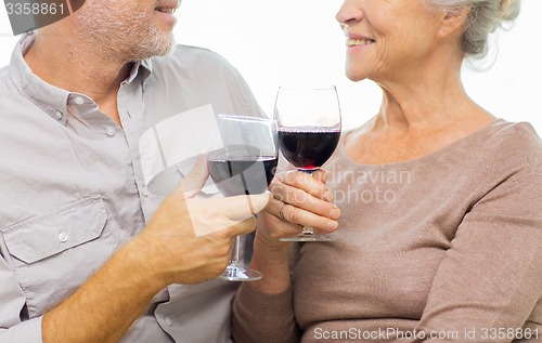 Image of close up of happy senior couple with red wine