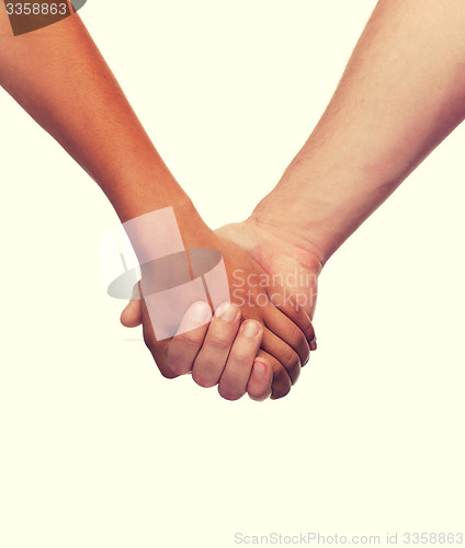 Image of woman and man holding hands