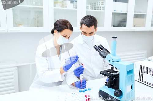 Image of young scientists making test or research in lab