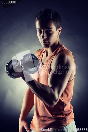 Image of young man with dumbbell