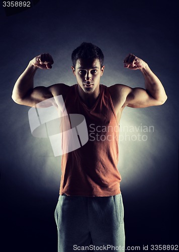 Image of young man showing biceps