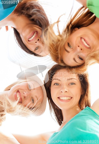 Image of faces of girls looking down and smiling