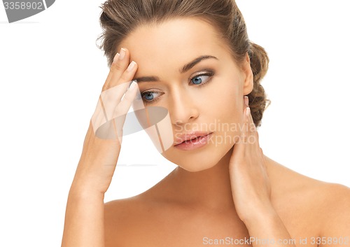 Image of woman holding hands on her neck and forehead