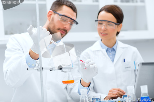 Image of young scientists making test or research in lab