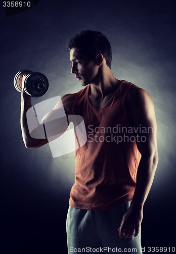 Image of young man with dumbbell