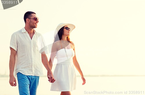 Image of smiling couple walking outdoors