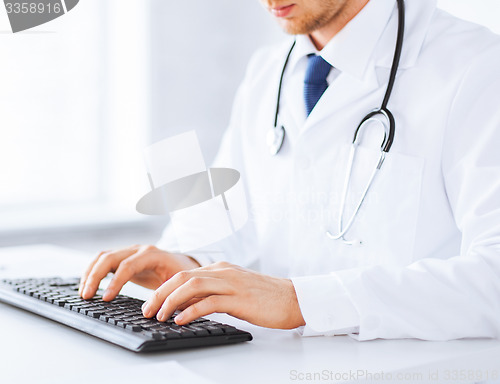 Image of male doctor typing  on the keyboard