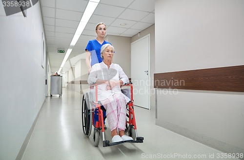 Image of nurse with senior woman in wheelchair at hospital