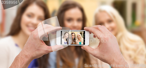 Image of close up of hands taking picture with smartphone