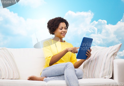 Image of happy african american woman with tablet pc